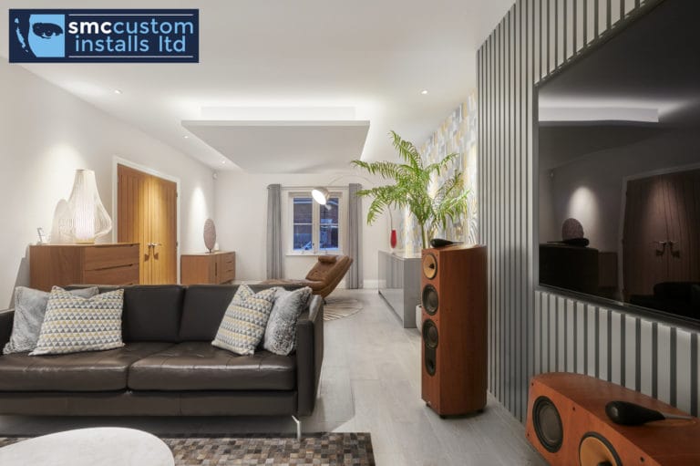 Living room with high-end floorstanding hi-fi speakers and dark slatted media wall