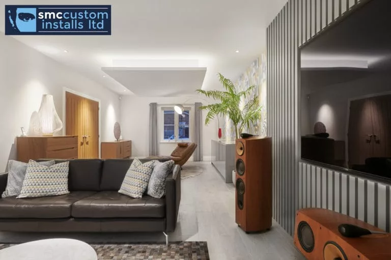 Living room with high-end floorstanding hi-fi speakers and dark slatted media wall