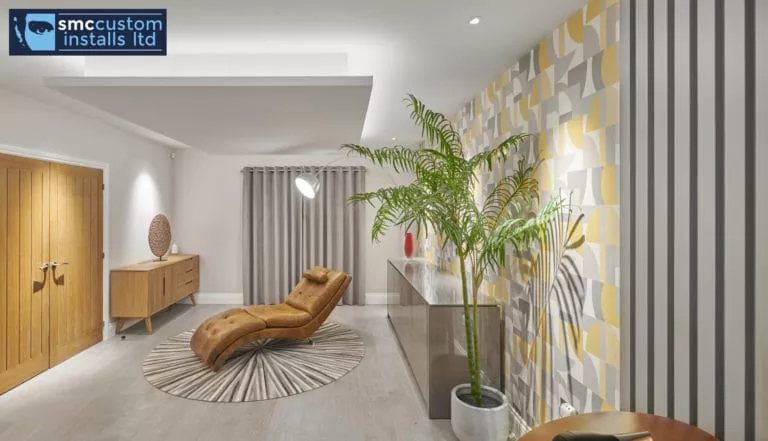 Lounge area with leather chaise, slatted timber wall and recessed feature ceiling lighting