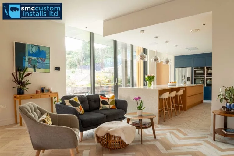Open-plan living and kitchen area with pendant island lighting and feature artwork