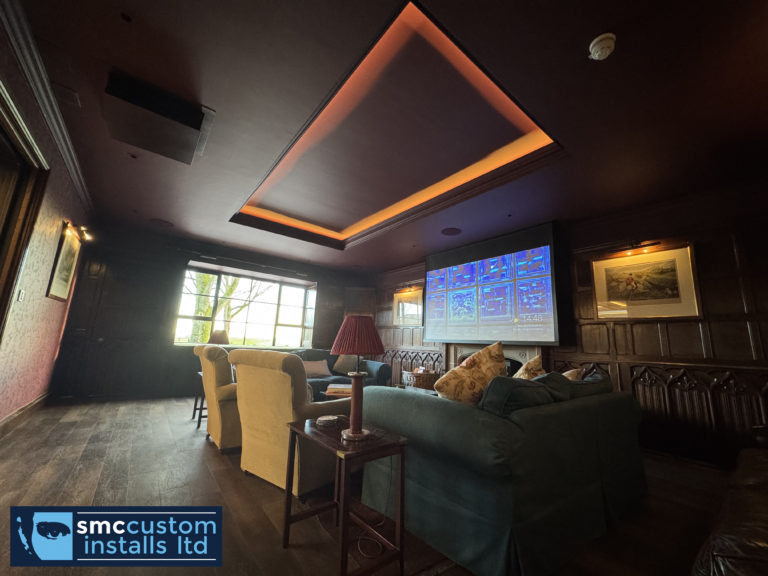 Rear view of the lounge cinema showing the projection screen and LED-lit coffered ceiling
